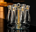 Gold leaf beer mug set with clear cups on a reflective surface