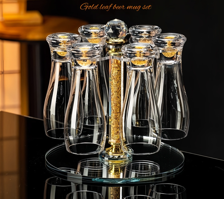 Gold leaf beer mug set with clear cups on a reflective surface