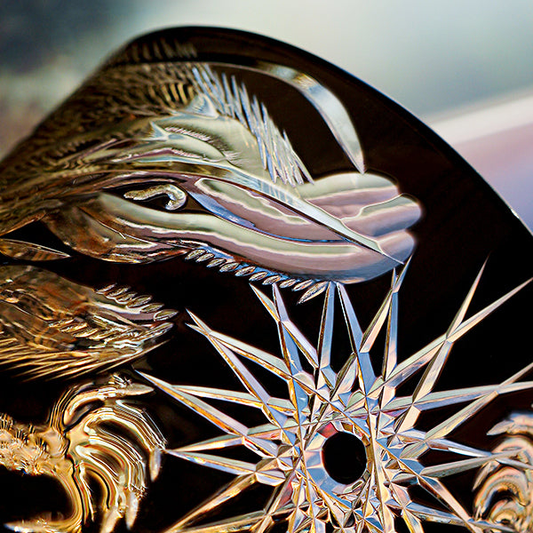 Close-up of a decorative emblem with intricate details on a vehicle.