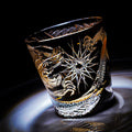 Decorative glass with intricate designs on a dark background