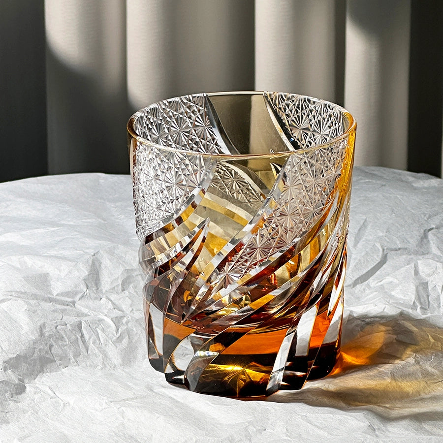 Decorative glass vase with intricate patterns on a textured surface