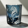 Decorative glass vase with horse design on a gray surface
