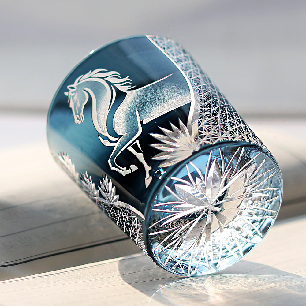 Decorative glass item with horse design on a reflective surface